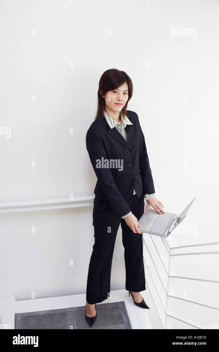 Portrait of a businesswoman holding a laptop Stock Photo
