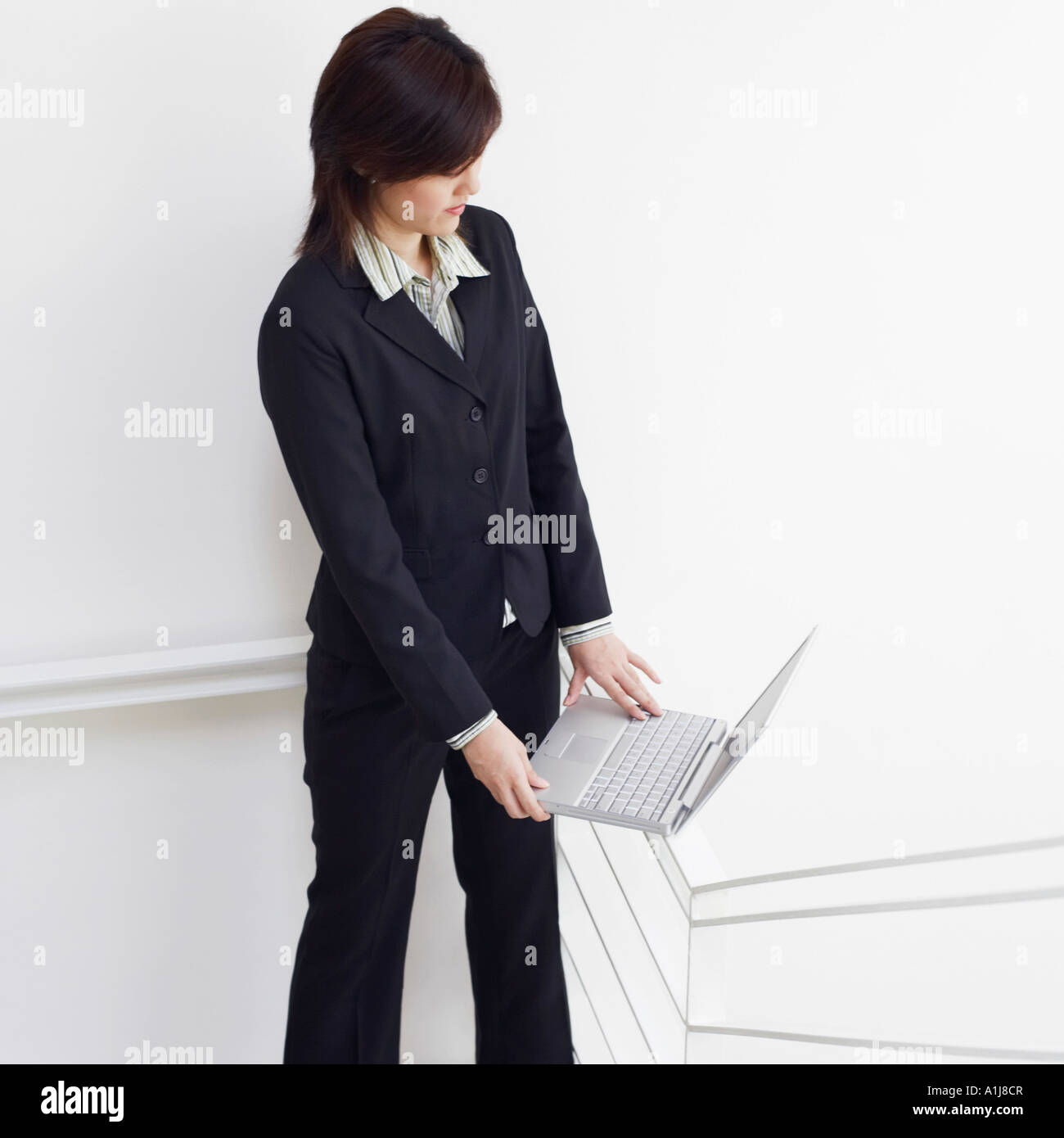 High angle view of a businesswoman using a laptop on the staircase Stock Photo