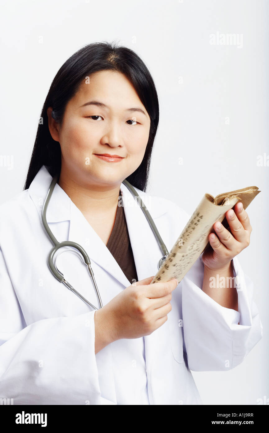Portrait of a female doctor holding a book Stock Photo