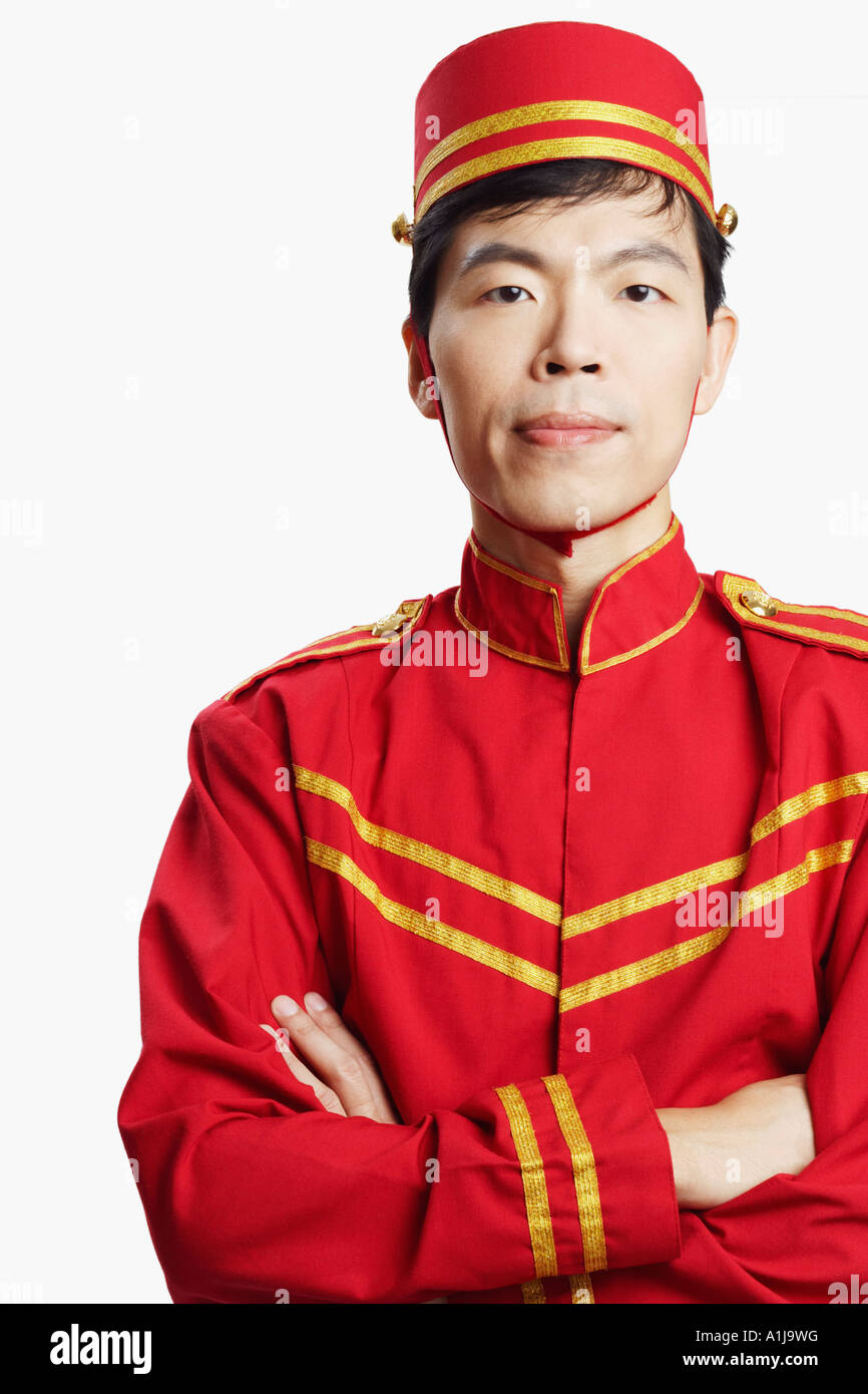 Portrait of a bellhop with his arms crossed Stock Photo Alamy