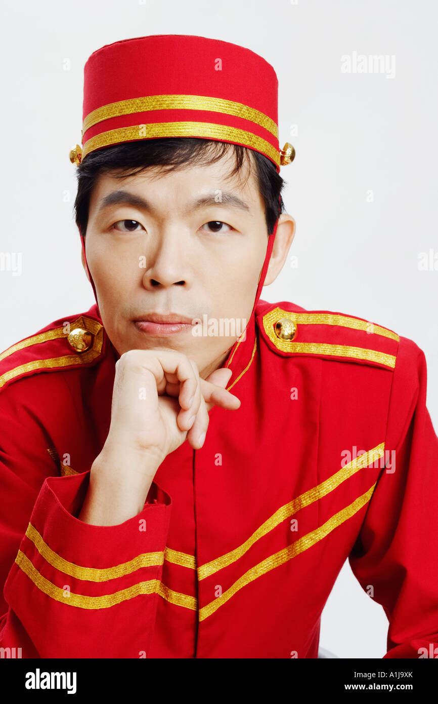 Portrait of a bellhop with his hand on his chin Stock Photo Alamy