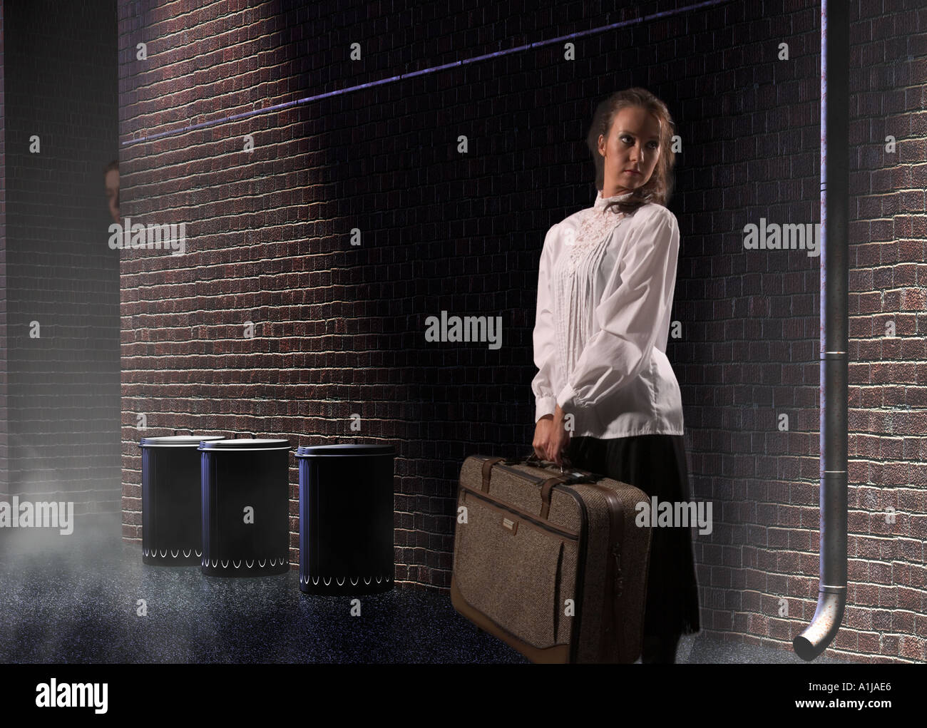 Caucasian Teen Girl Runaway Standing in Dark Alley with Suitcase USA Stock Photo