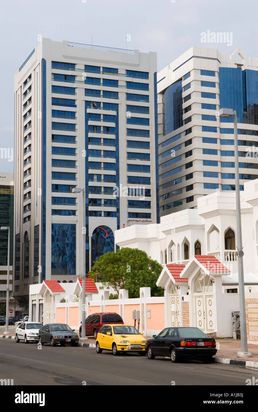 United Arab Emirates UAE  Typical expensive family housing in centre of Abu Dhabi hotel and office block behind Stock Photo