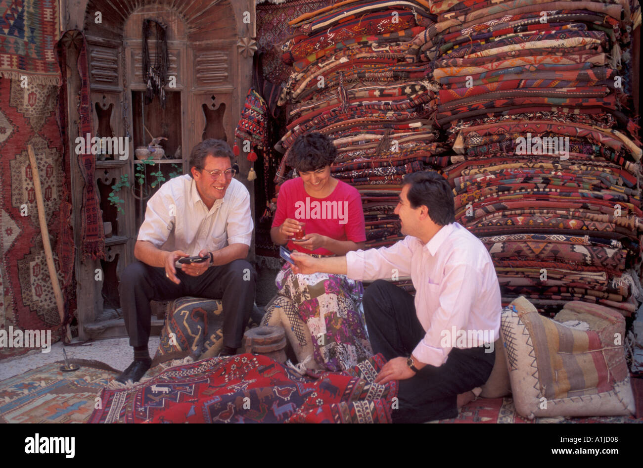 Turkey Goreme turkish carpet salesman taking credit card from clients Stock Photo