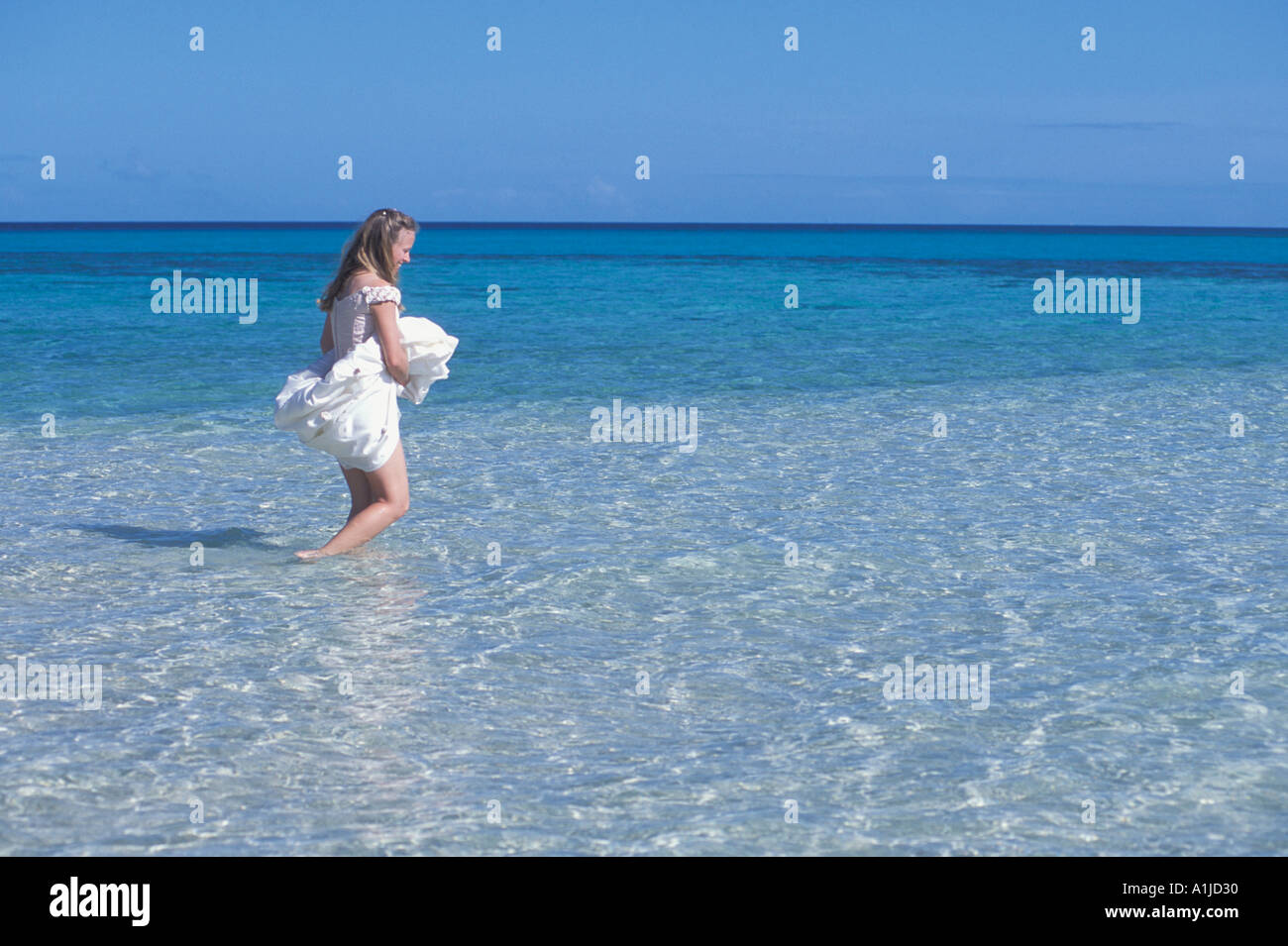 Woman in dress wading in water hi-res stock photography and images - Alamy