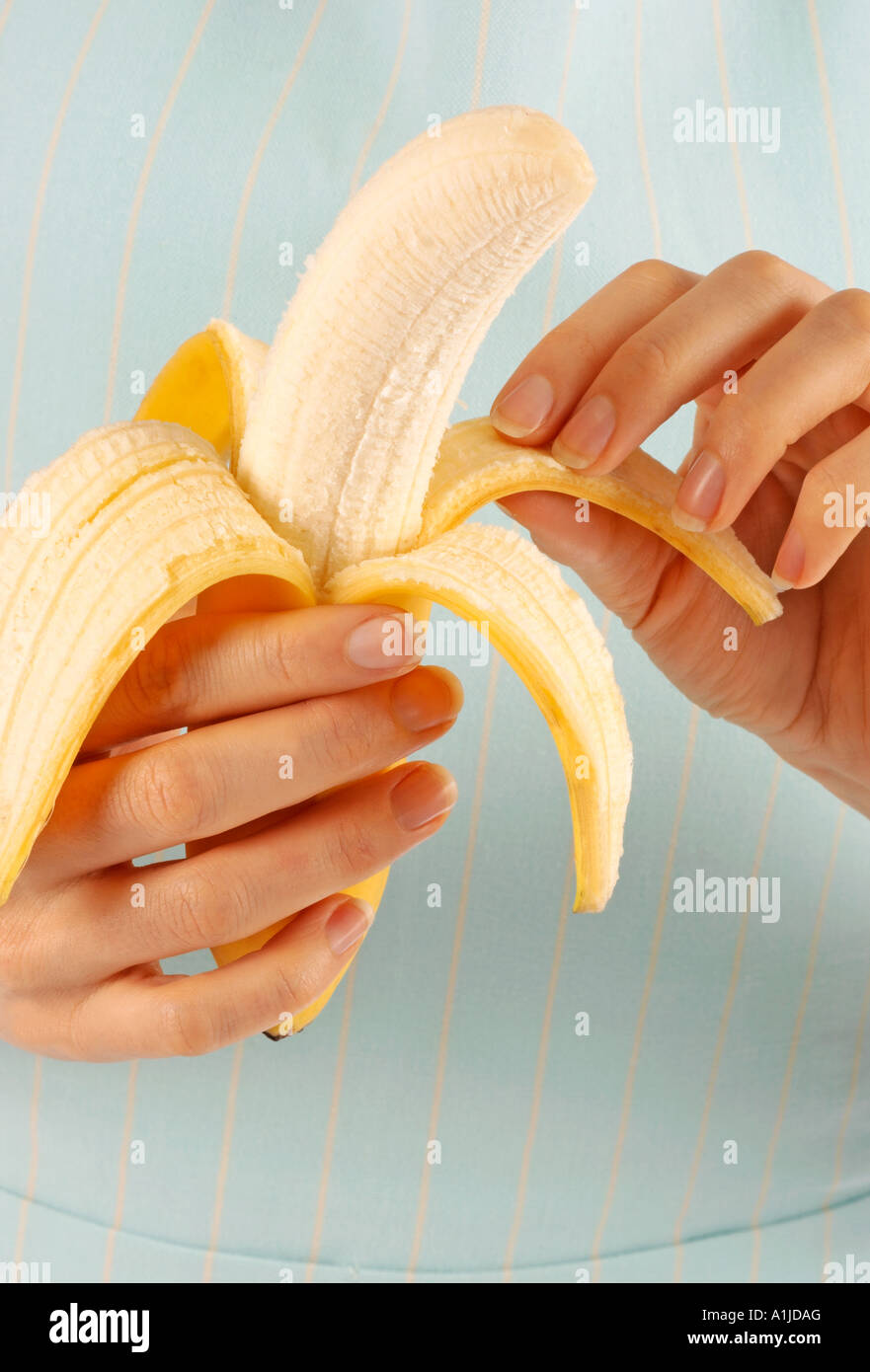 Woman peeling banana bananas in hi-res stock photography and images - Alamy