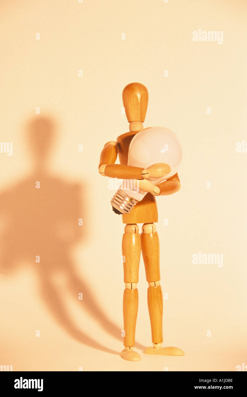 Artists mannequin holding lightbulb Stock Photo