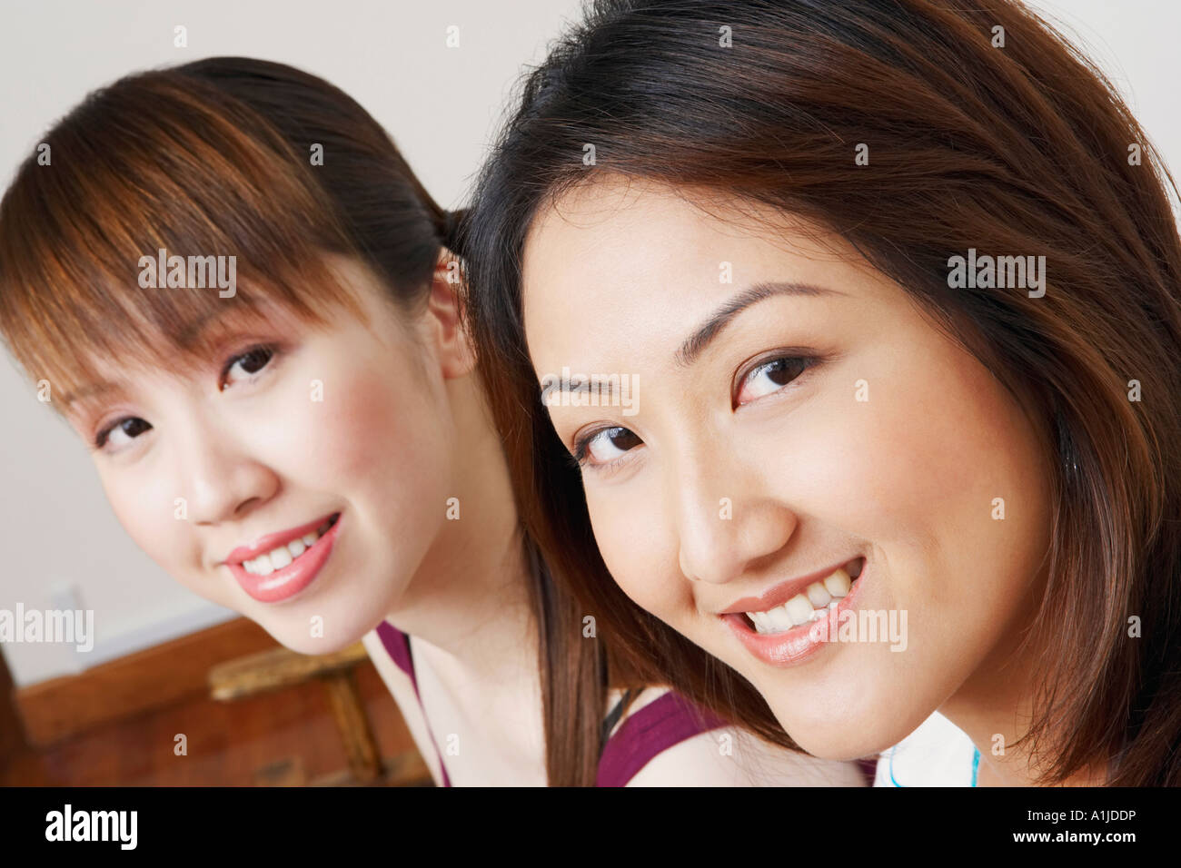 Portrait of two young women smiling Stock Photo - Alamy