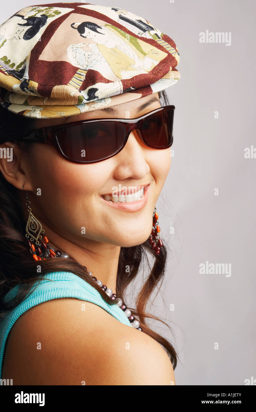 Portrait of a young woman wearing sunglasses and smiling Stock Photo ...