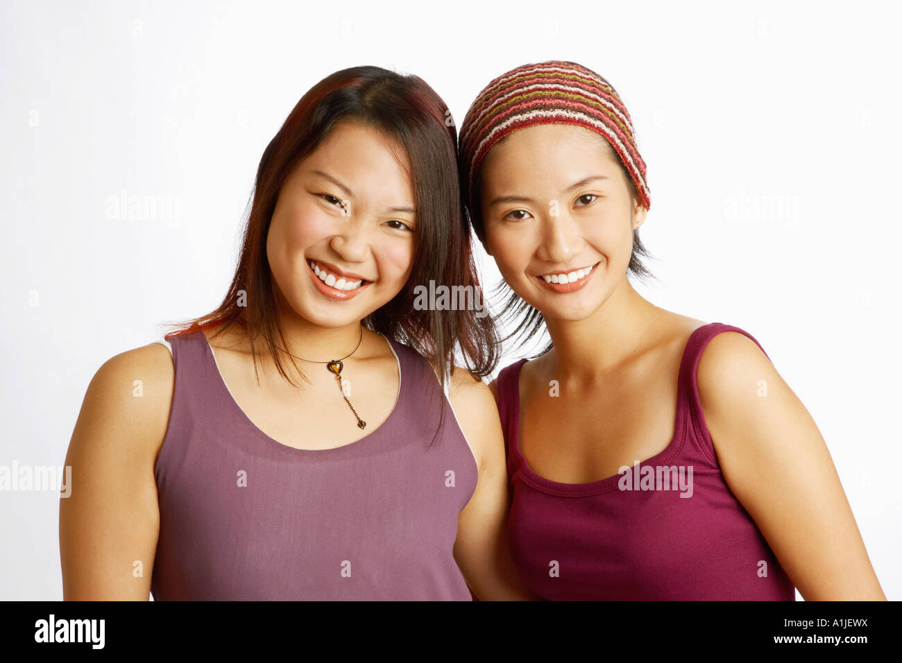 Portrait of two young women posing and smiling Stock Photo - Alamy