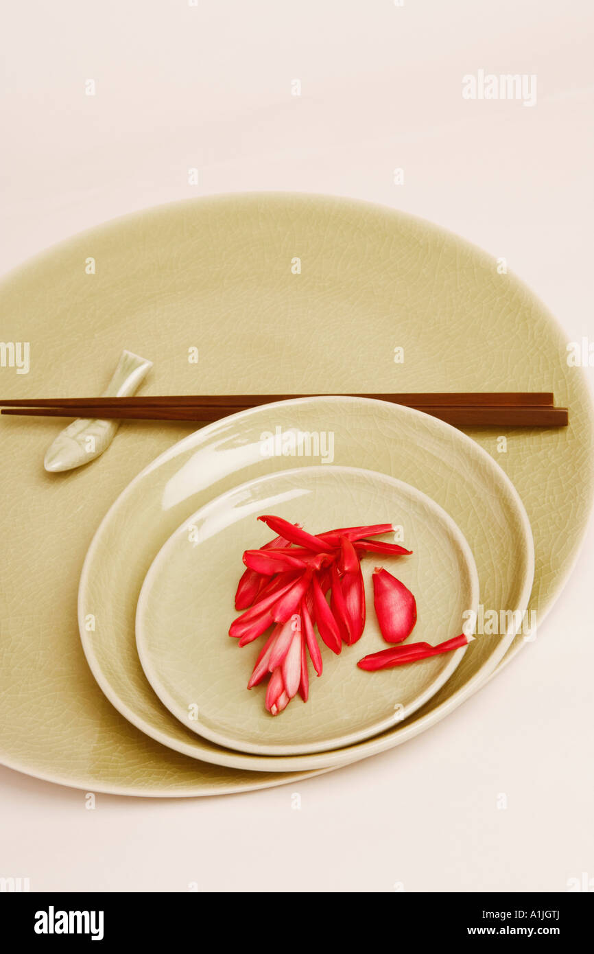 High angle view of flower petals and chopsticks in a plate Stock Photo