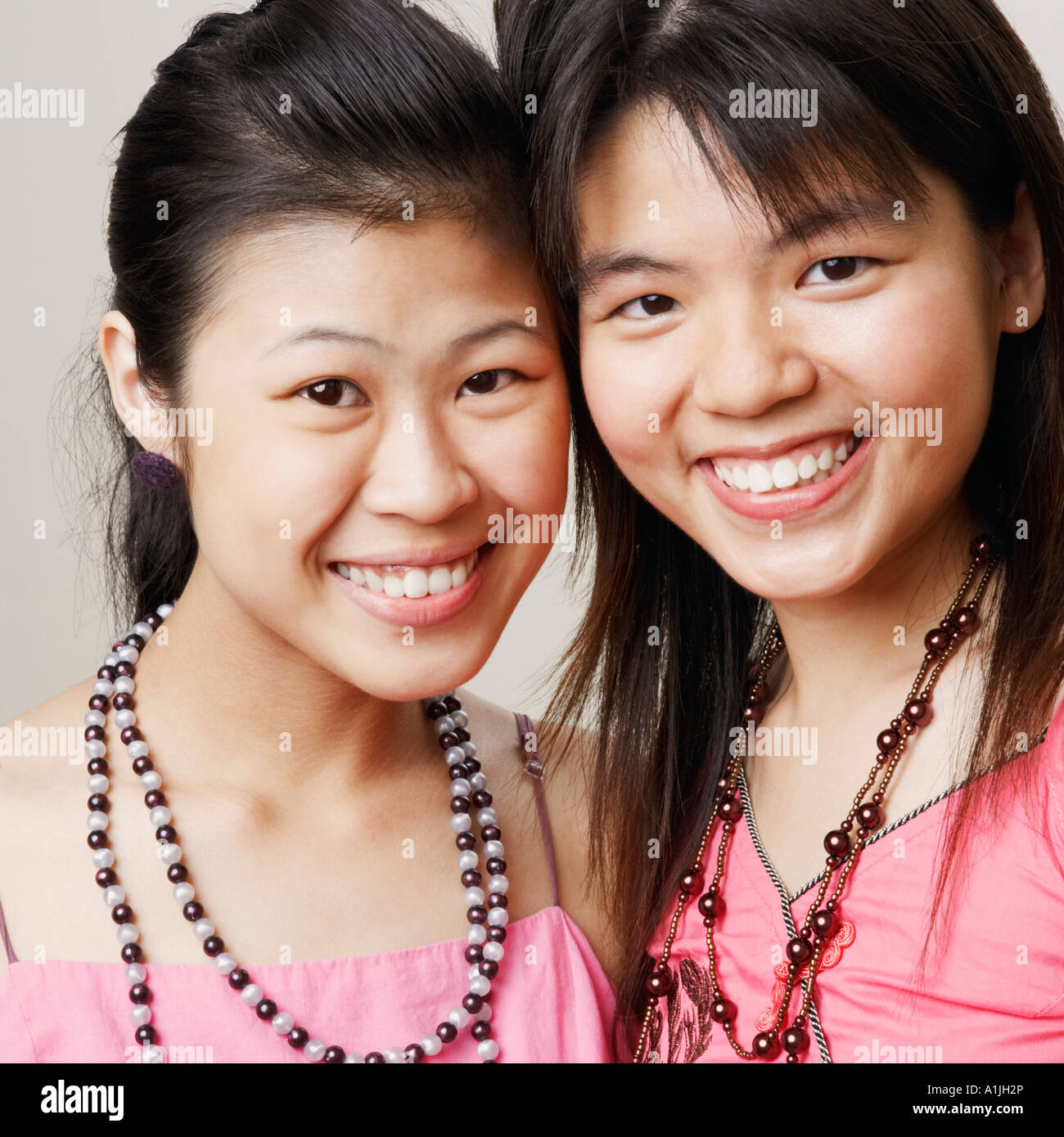 Portrait of two young women smiling Stock Photo - Alamy