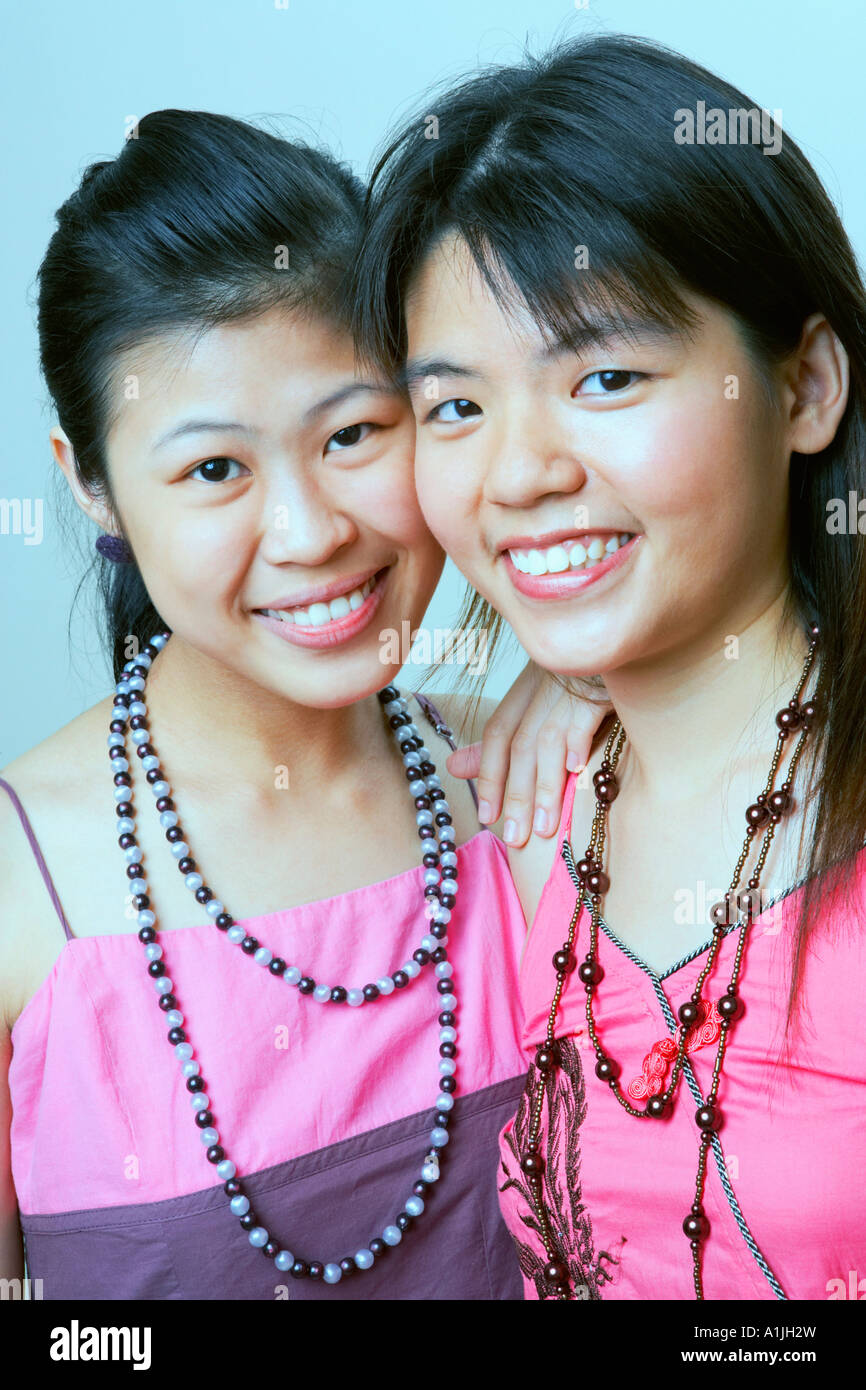 Portrait of two young women smiling Stock Photo - Alamy