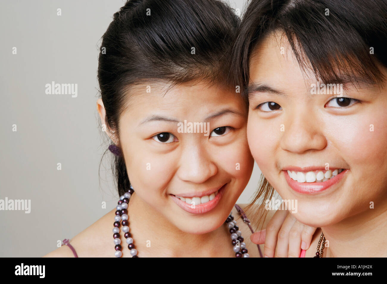 Portrait of two young women smiling Stock Photo - Alamy