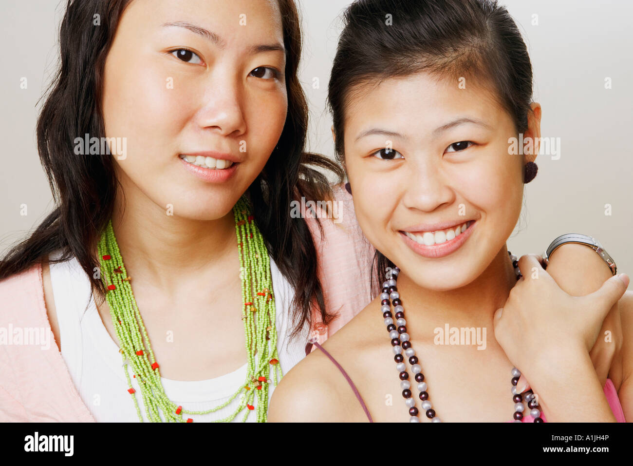 Portrait of two young women smiling Stock Photo - Alamy