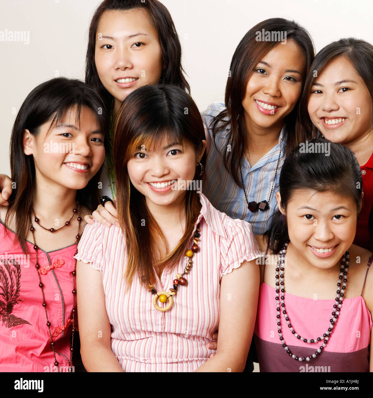 Portrait of four young women hugging each other and posing Stock Photo ...