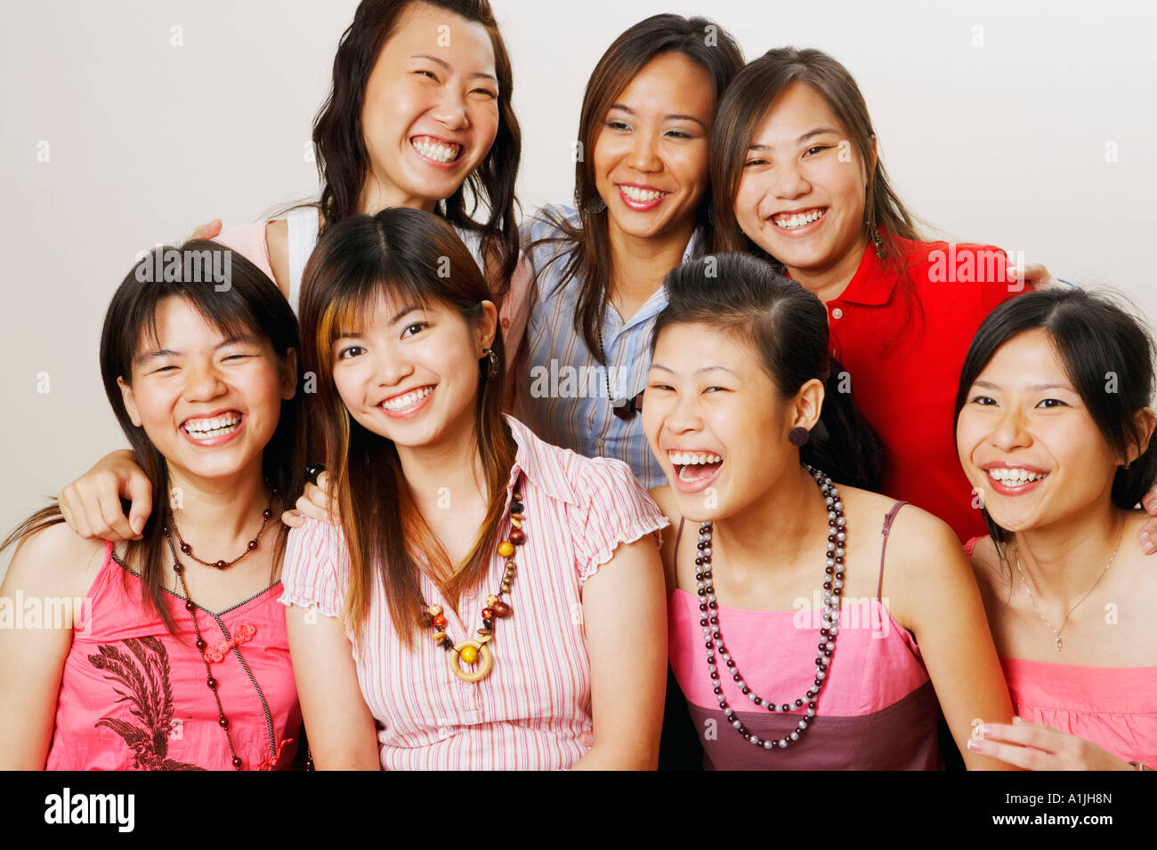 Group of young women sitting together and looking cheerful Stock Photo ...