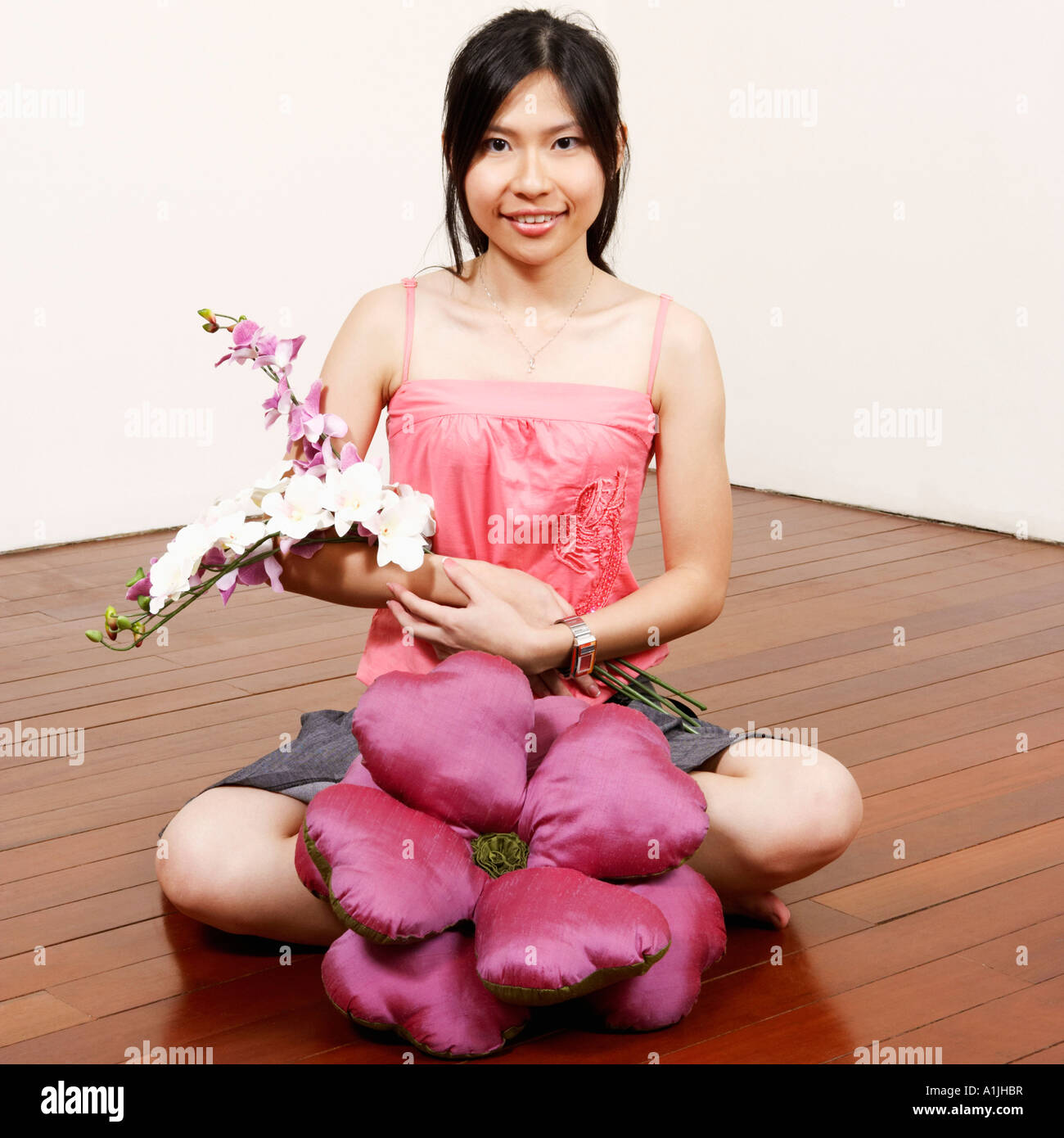 Portrait of a young woman holding flowers and smiling Stock Photo - Alamy