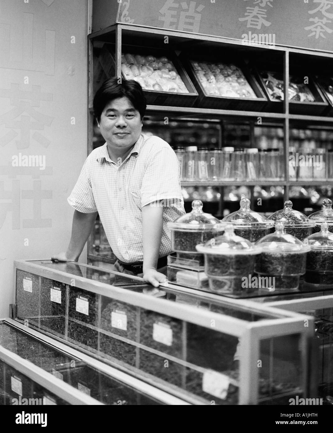 Portrait of a shopkeeper standing at the checkout counter Stock Photo