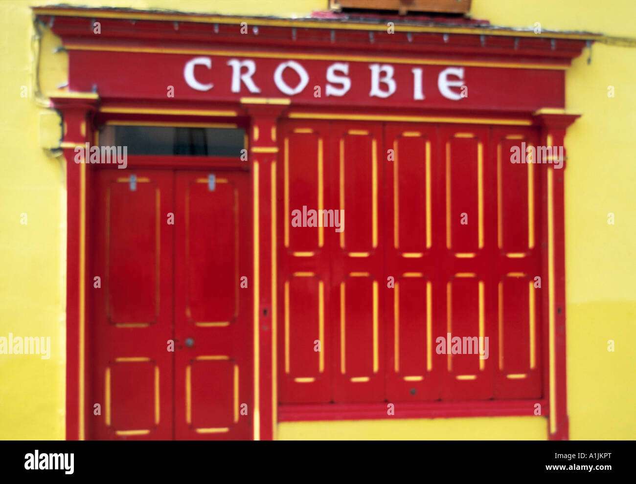 village, county limerick, ireland, brightly painted irish  pub bar  frontal view of an old village pub Stock Photo