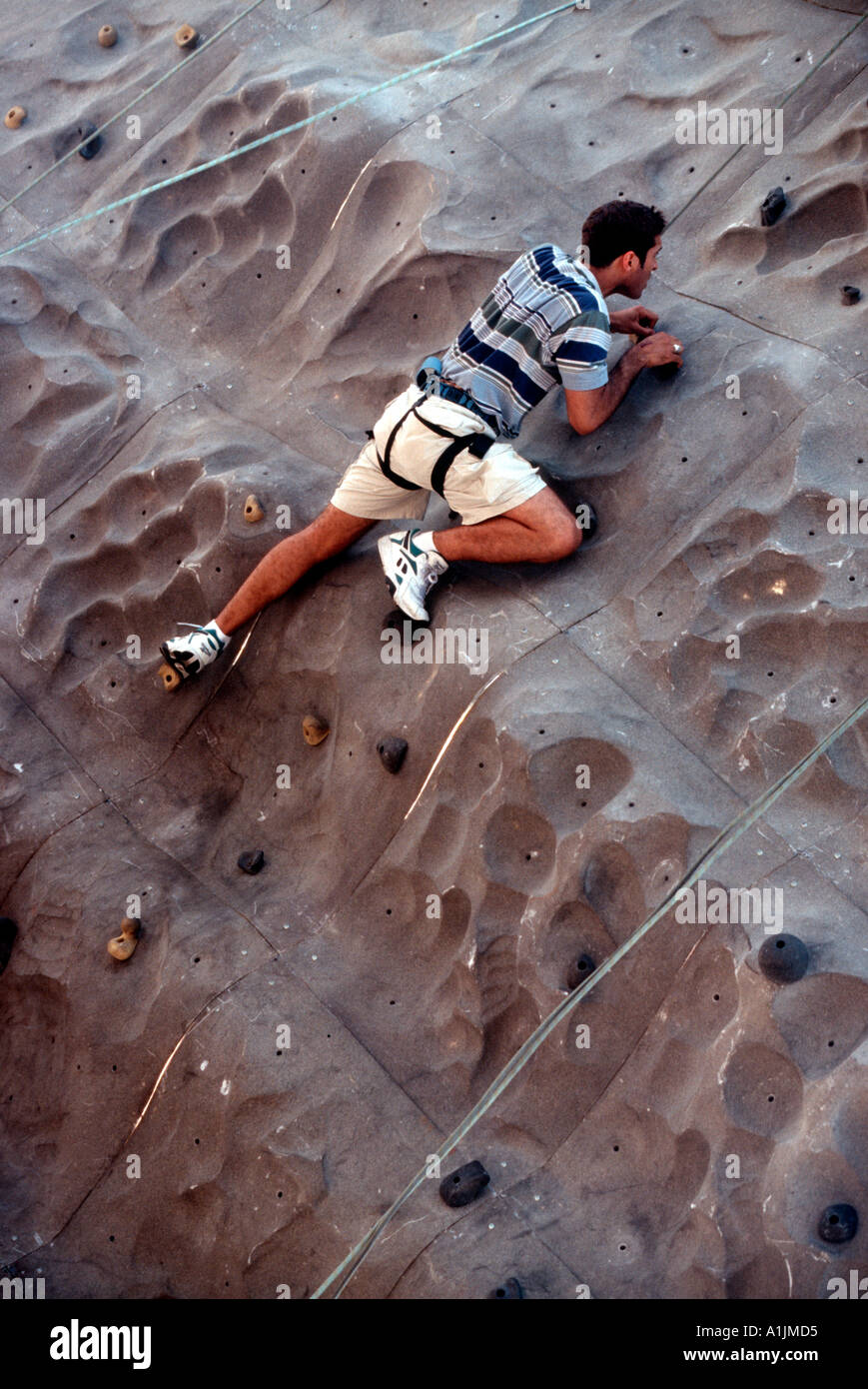 Sports enthusiast on climbing wall Stock Photo Alamy