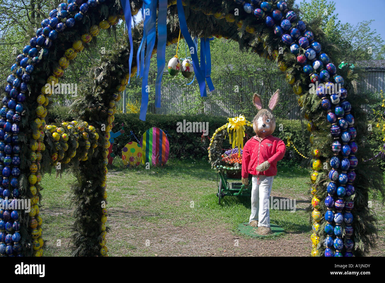 a Giant Easter Bunny is pulling a wagon full with colorful painted easter eggs Stock Photo Alamy