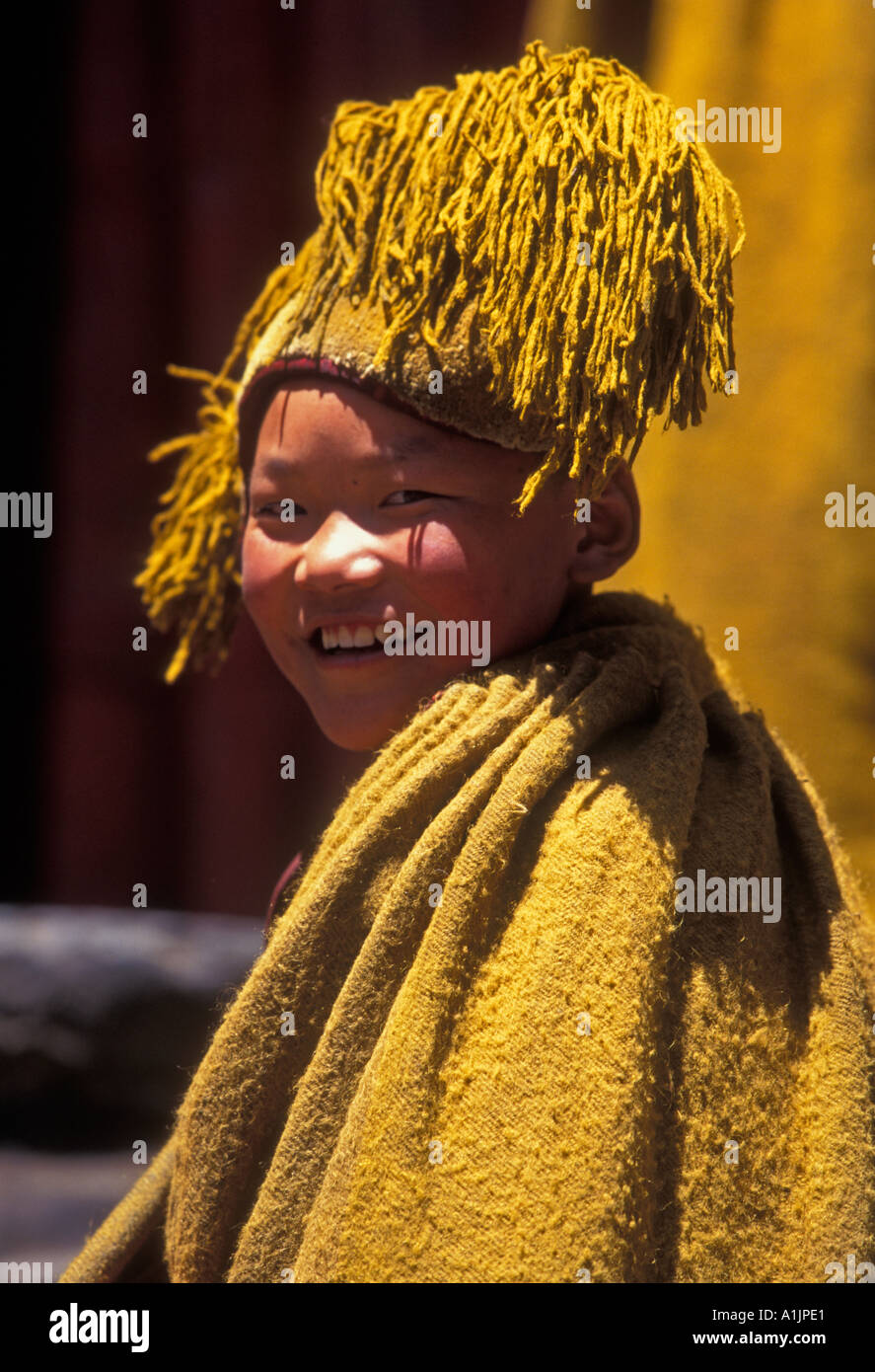 1, one, Tibetan boy, Tibetan monk, novice monk, eye contact, portrait, Yellow Hat monk, Kelsang Temple, Tashilhunpo Monastery, Shigatse, Tibet, China Stock Photo