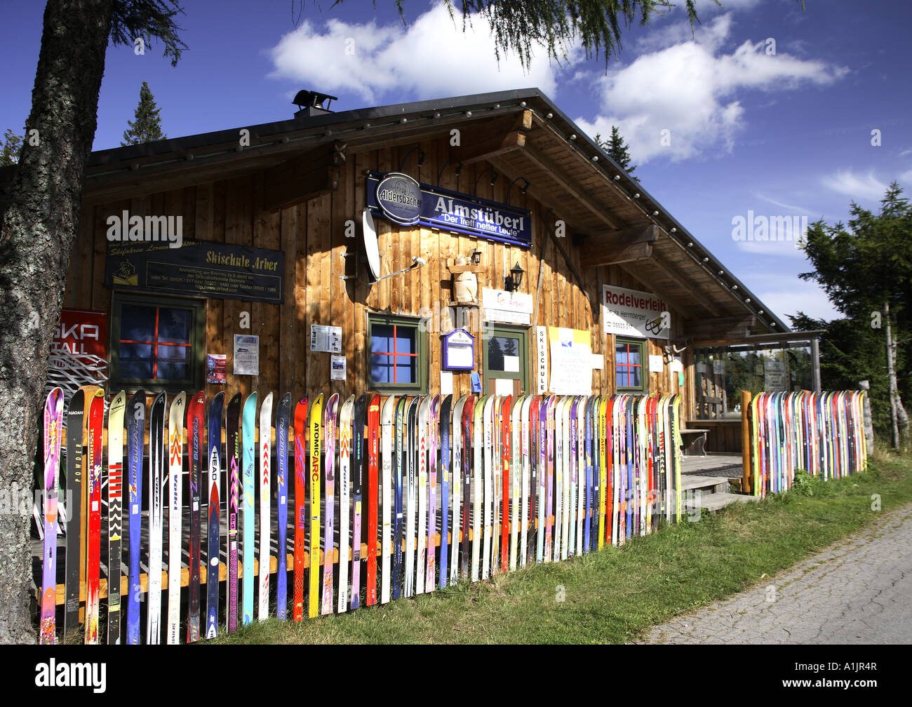 Old broken skis are used to build up a colorful fence. Stock Photo