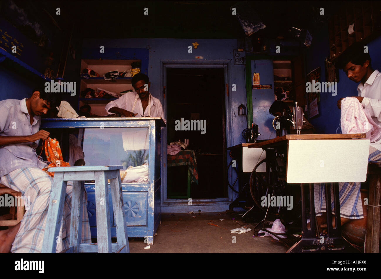 Men working in a tailor workshop Tamil Nadu South India Stock Photo