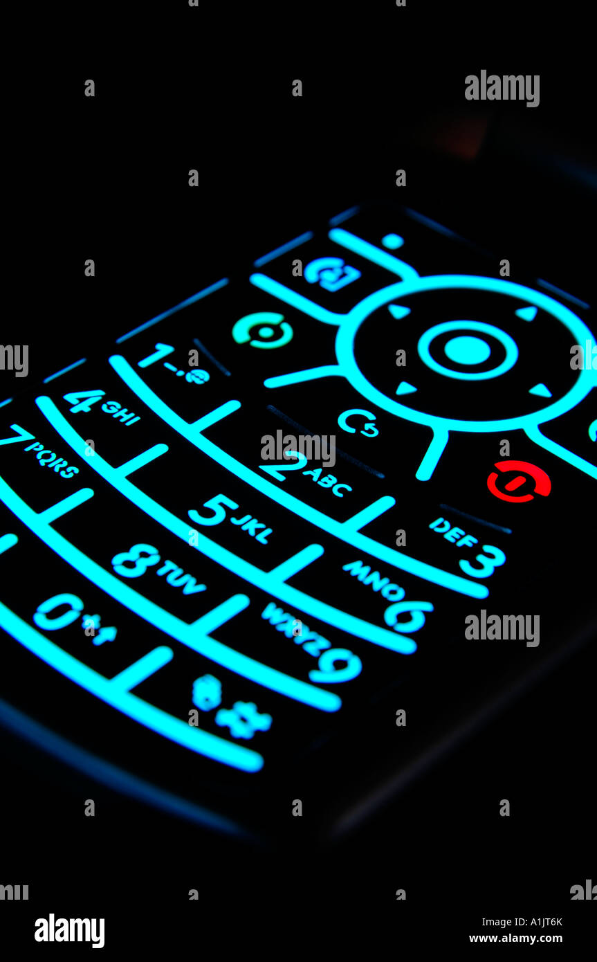 Illuminated keypad of modern mobile phone againt a black background Stock Photo