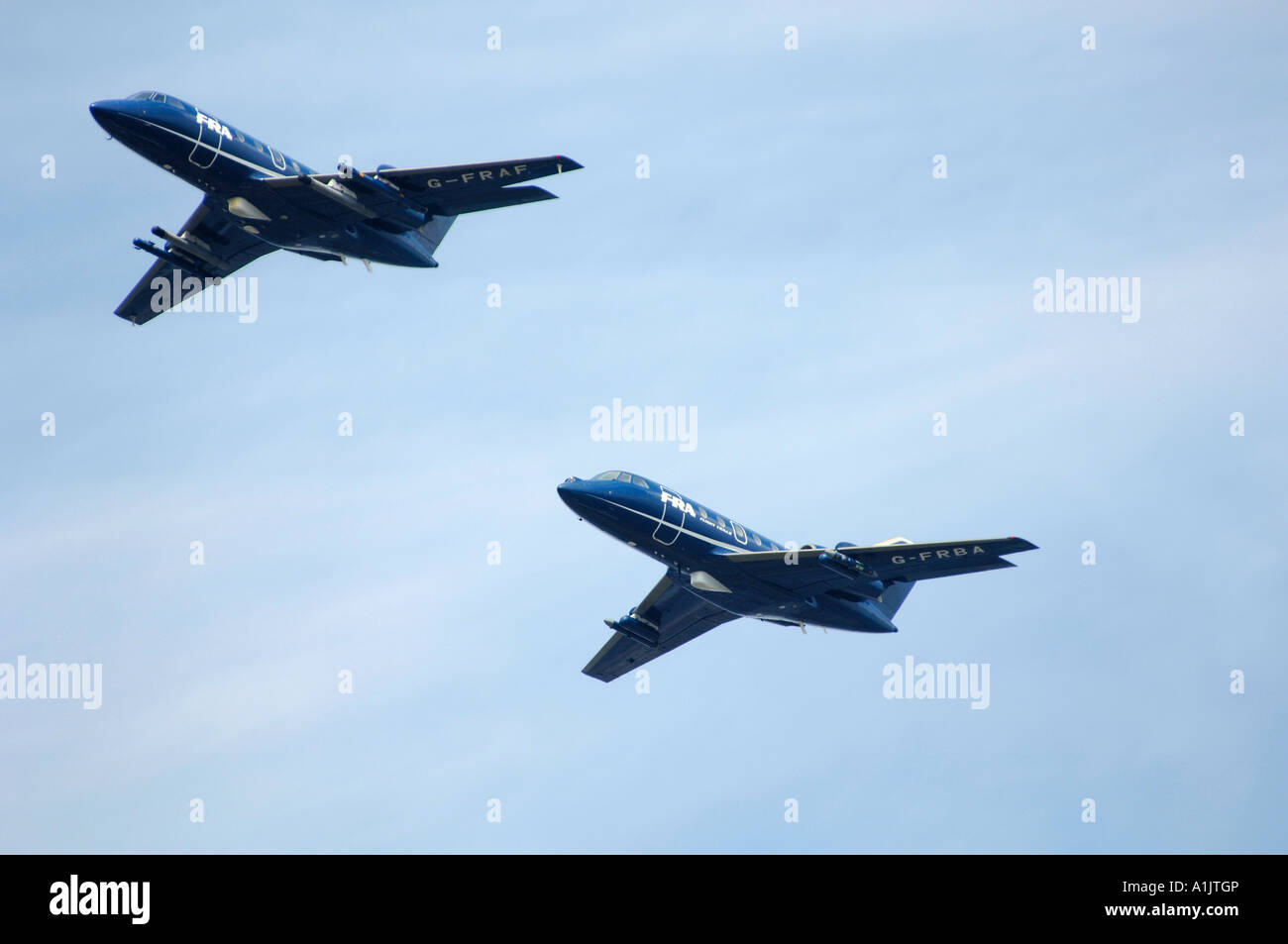 Two Dassault Falcon 20  aircraft owned by FR Aviation flying in formation at the Farnborough International Airshow 2006 Stock Photo