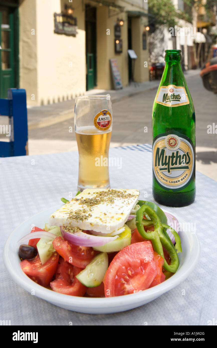 Greek Salad and Mythos beer at a taverna in the town centre, Nafplion, Peloponnese, Greece Stock Photo