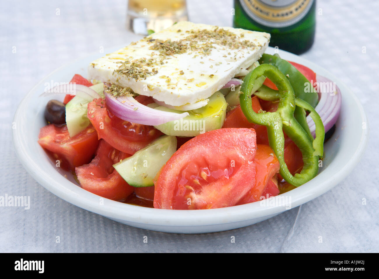 Greek Salad and Mythos beer at a taverna in the town centre, Nafplion, Peloponnese, Greece Stock Photo