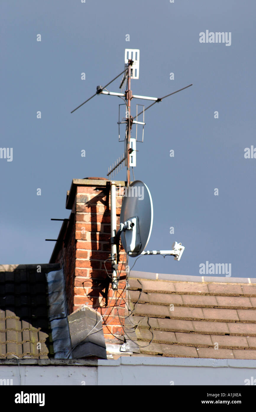 Television aerials and satellite dish on chimney stack Stock Photo Alamy