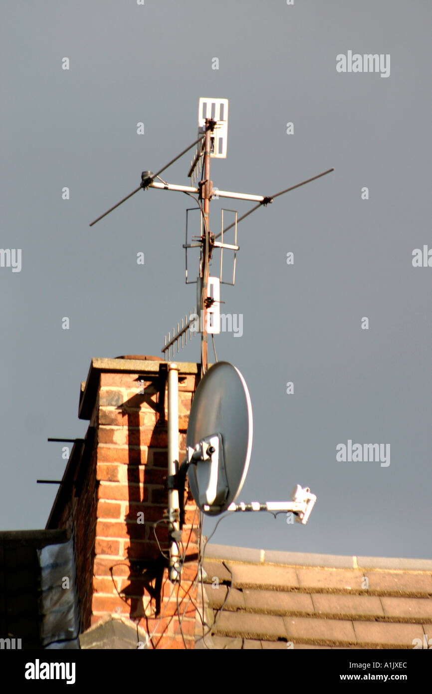 Television aerials and satellite dish on chimney stack Stock Photo Alamy