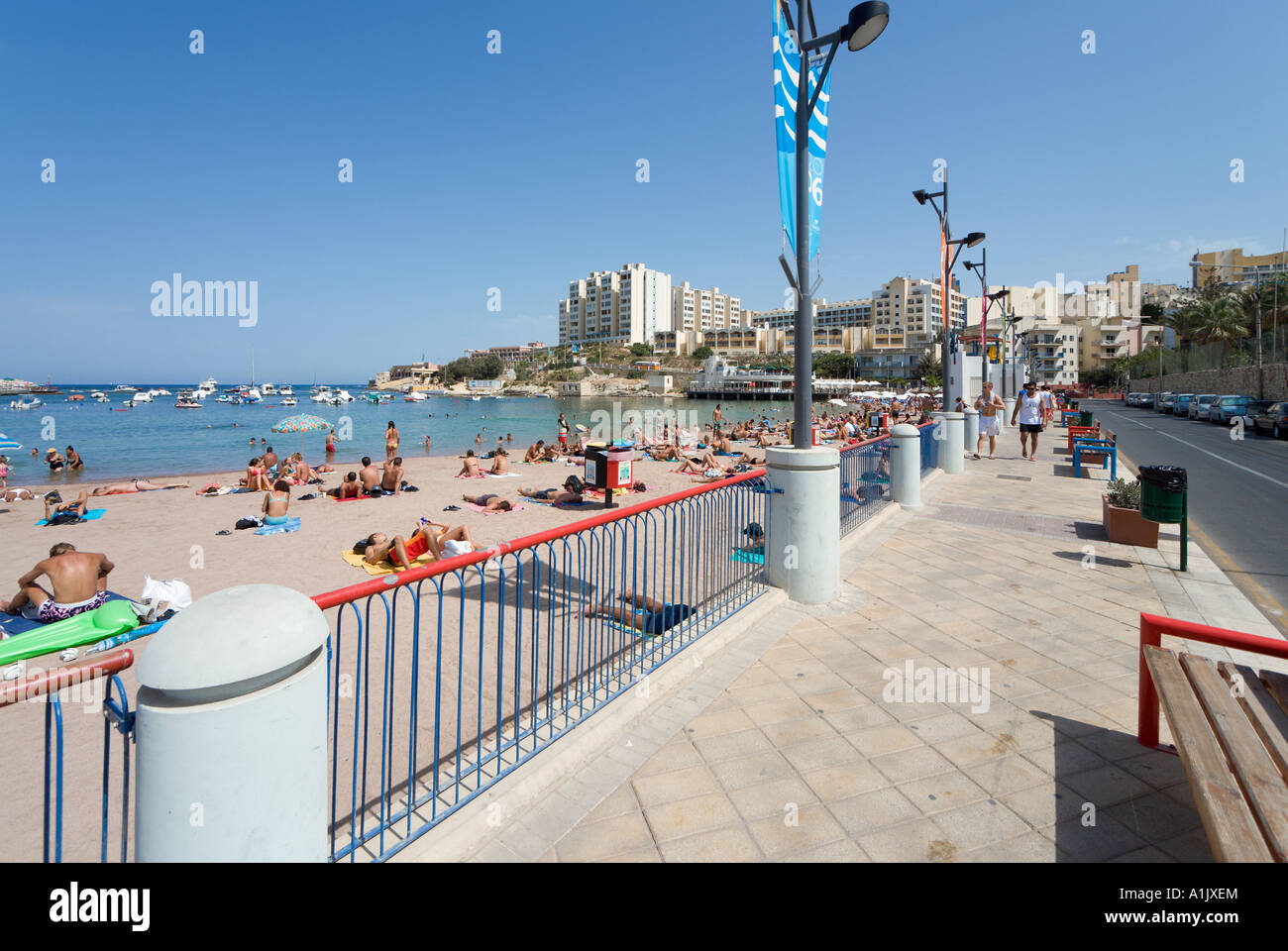 Beach and seafront promenade at St George's Bay, Malta Stock Photo