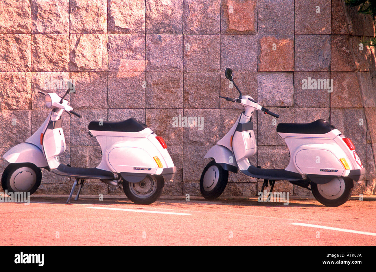 Pair of parked white Vespa 50 motor scooters Porto Cervo Sardinia Italy Stock Photo