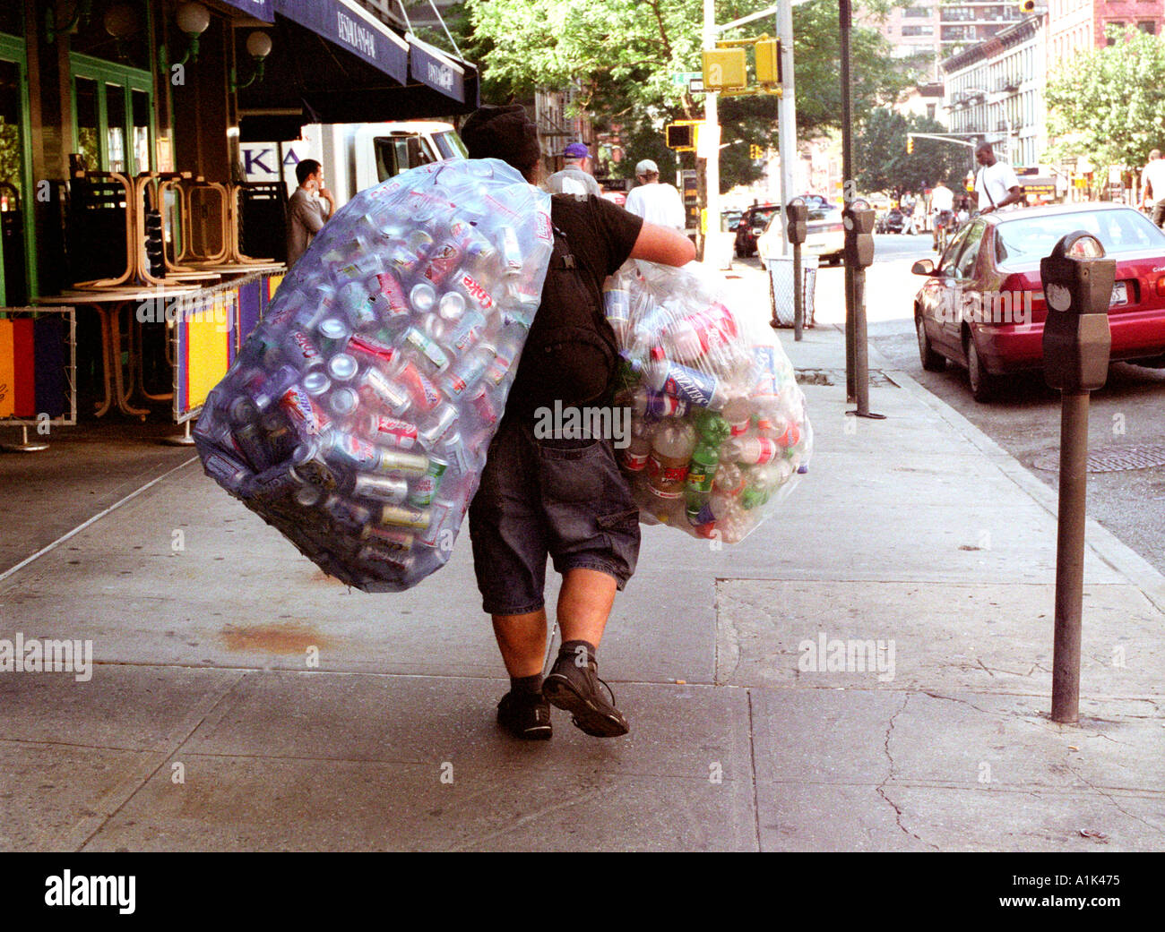 Homeless man collecting tin cans to recycle for money Stock Photo Alamy