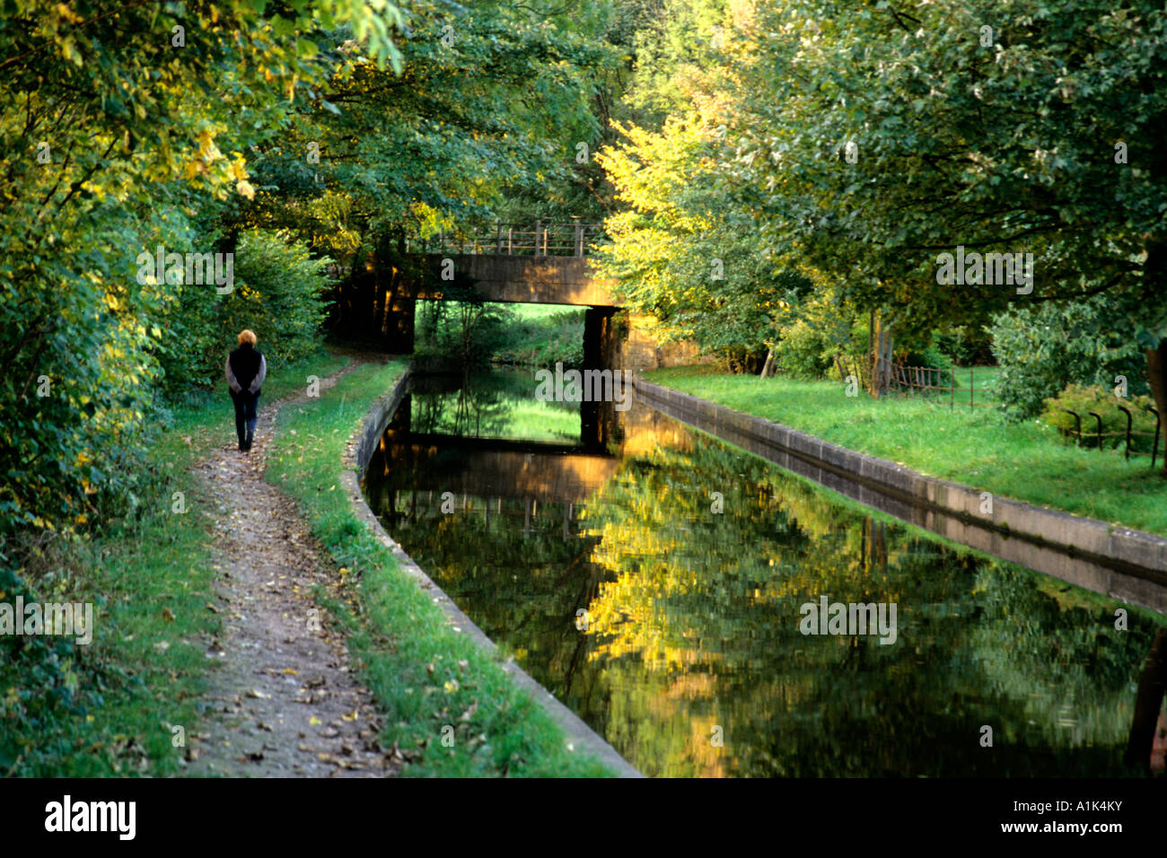 Woman walks the towpath along a narrow canal in Llangollen Wales, Great Britain Stock Photo