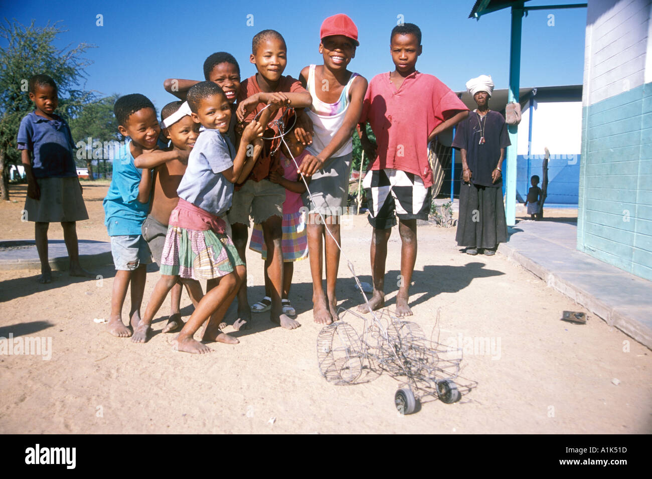San children playing with handmade toys in small town of Drimiopsis in Central eastern Namibia San bushmen have an oriental Stock Photo