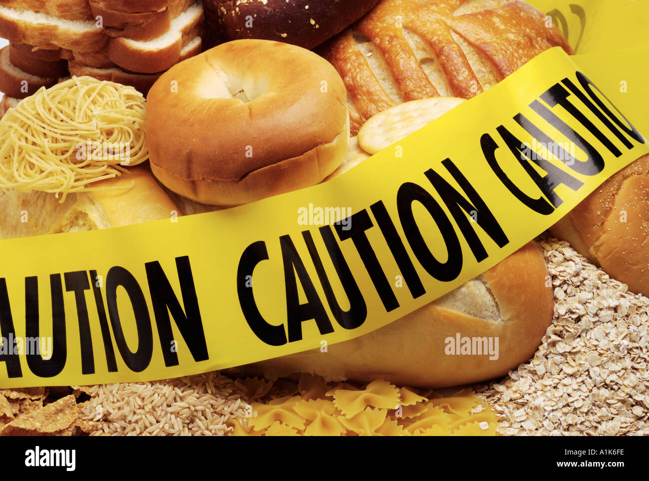 Low carbohydrate diet Background of bread cereal products surrounded with caution tape Stock Photo