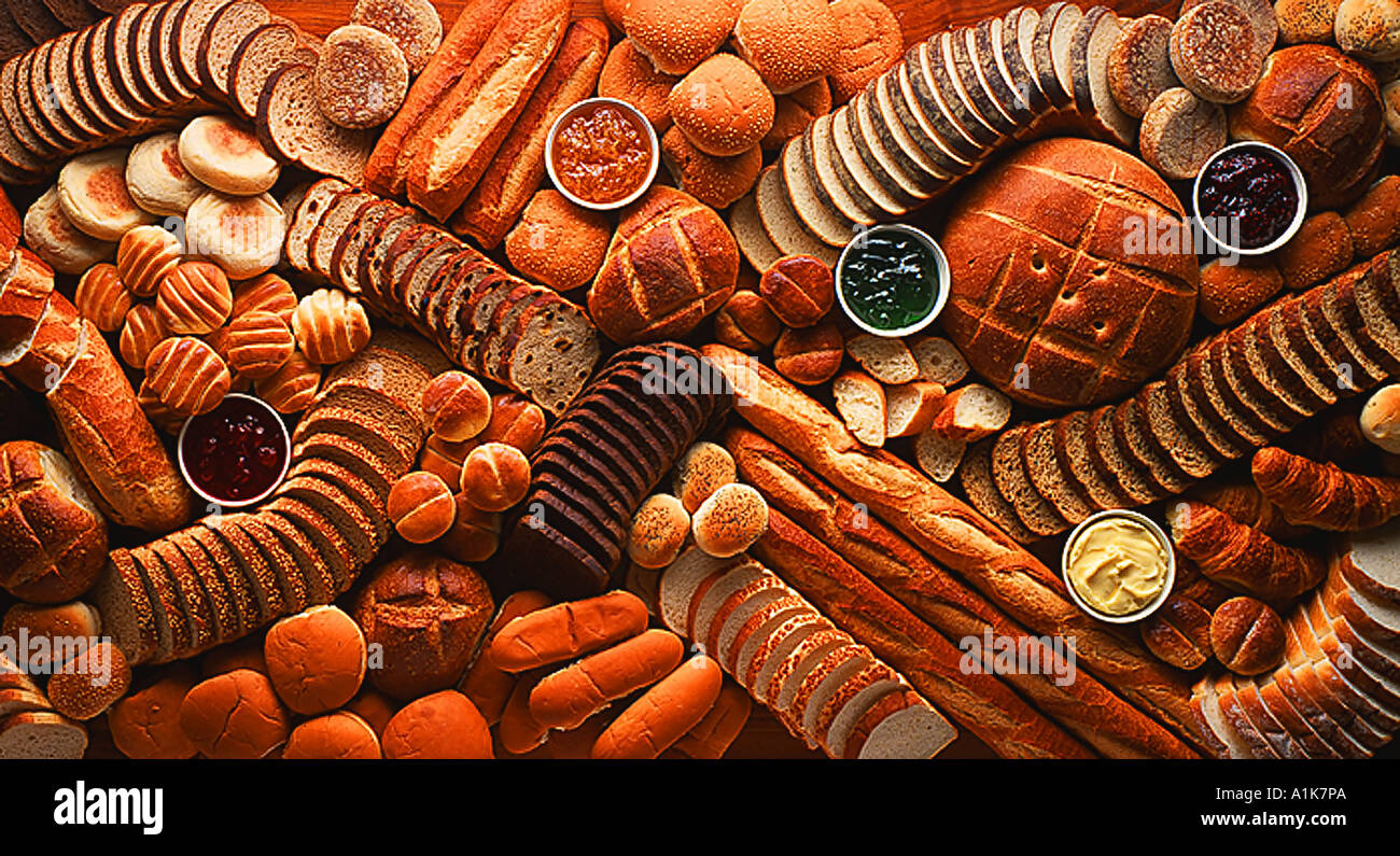 studio display of various bread types jams and jellies Stock Photo