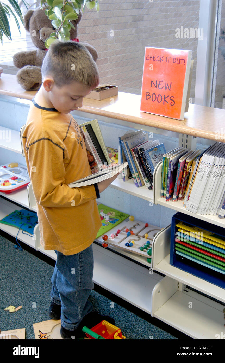 Boy looks at new books at library Stock Photo