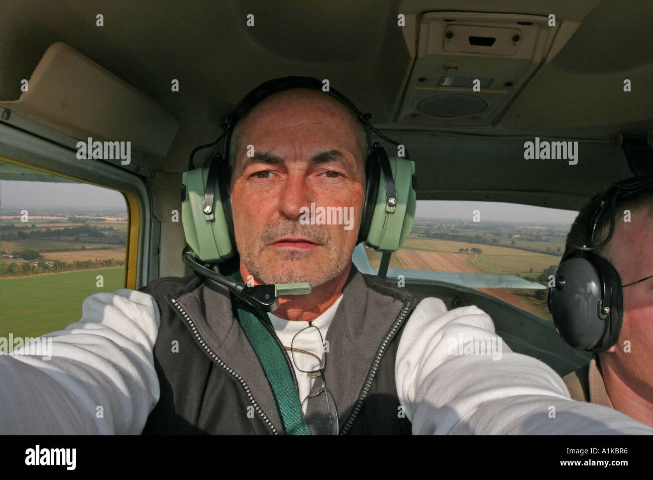 A middle aged pilot flying a small Cessna aircraft Stock Photo