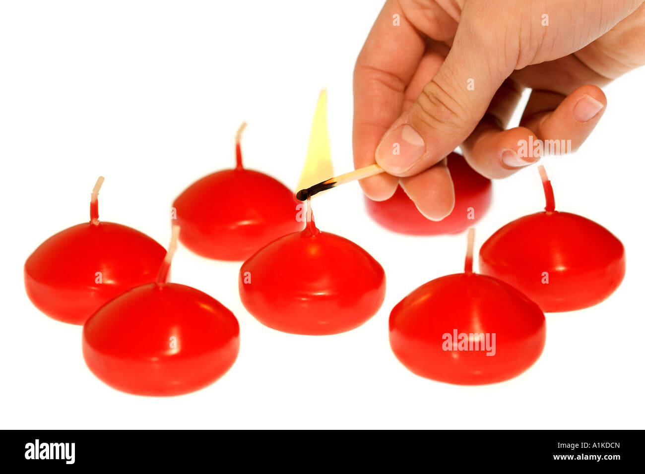 Lighting up red candles Stock Photo Alamy