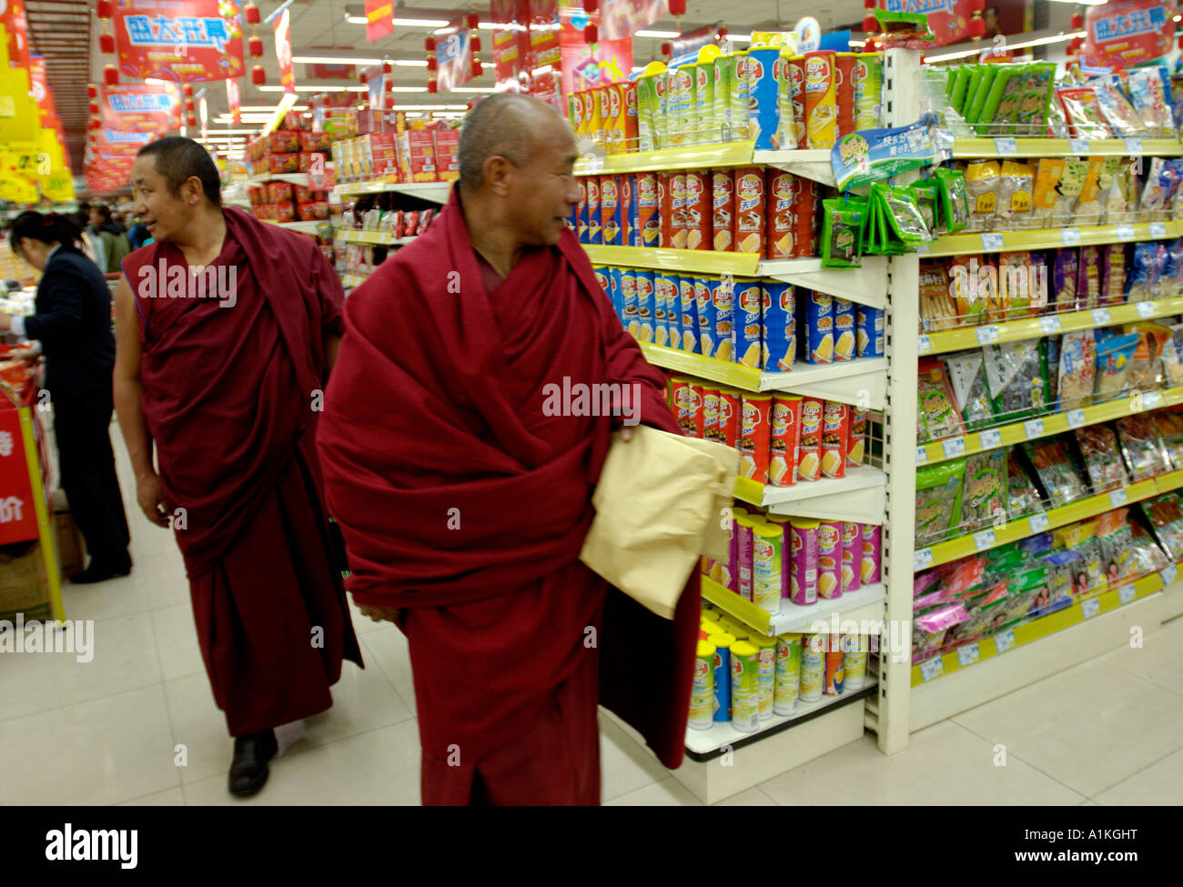 Tibetan monks shopping in a supermarket in Lhasa Tibet 22 OCT 2006