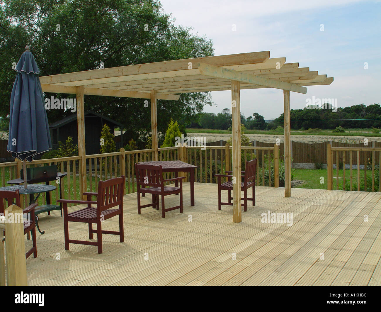 Timber garden decking with balustrades and pergola Stock Photo