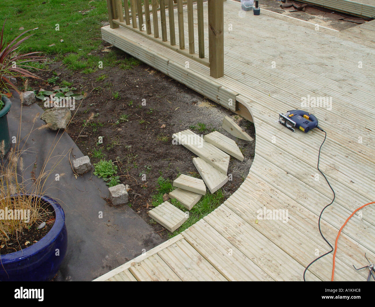 deck construction showing curve being cut out of the timber decking