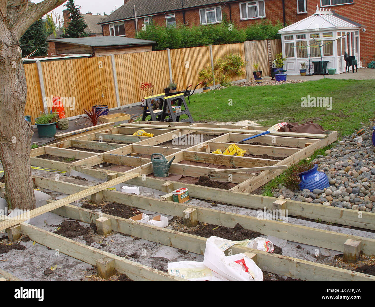 Decking construction showing deck joists being positioned Stock Photo