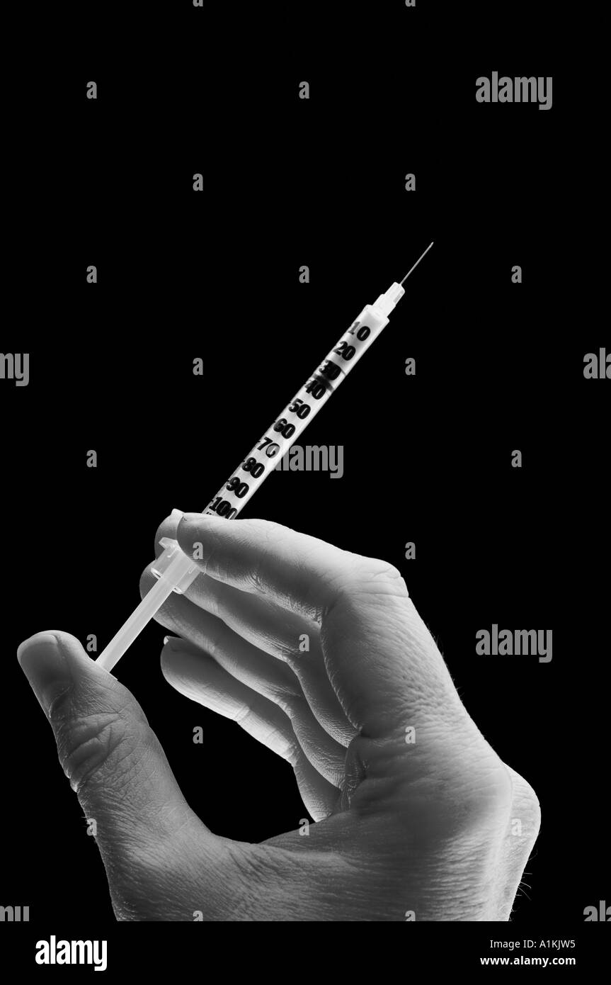 syringe hand with a syringe Stock Photo